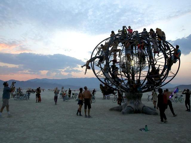 Participants climb an the Eidolon Panspermia Ostentatia Duodenum (EPOD) art installation during the Burning Man 2014 "Caravansary" arts and music festival in the Black Rock Desert of Nevada. (Reuters Photo)