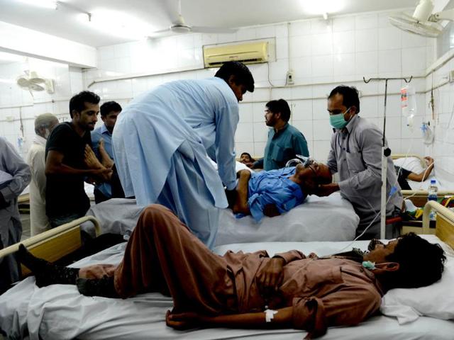 Pakistani paramedics move an injured policeman at a hospital after clashes with protesters in Islamabad on Sunday. (AFP PHOTO)