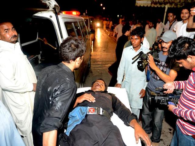 Pakistani paramedics shift an injured frontier constable at a hospital after the clashes in Islamabad on Sunday. (AFP PHOTO)
