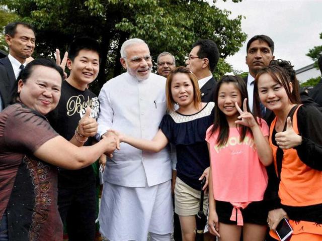 PM Narendra Modi poses for a photo with tourists during his visit at Golden Pavilion, Buddhist temple in Kyoto. (PTI Photo)