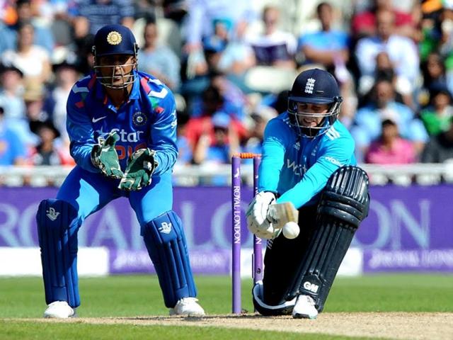 Joe Root strikes the ball as he is watched by India skipper MS Dhoni (L) during the fourth ODI between England and India at Edgbaston in Birmingham. (AP Photo)