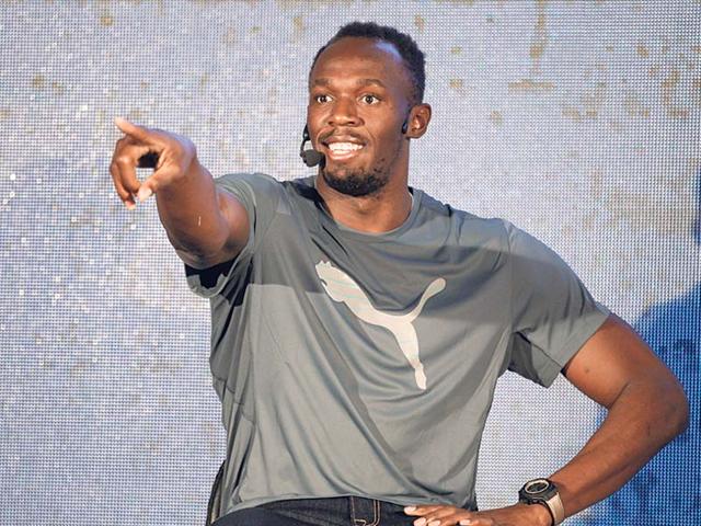 Bolt gestures towards an athlete during an interaction with Indian runners and journalists in Bangalore,India on September 2, 2014. (AP/Aijaz Rahi)