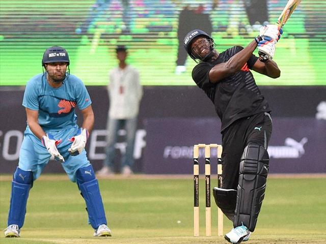 Bolt hits a six leading his team to a victory in the friendly cricket match in Bengaluru. (PTI/Shailendra Bhojak)