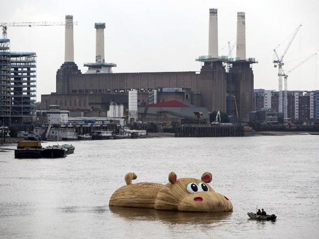 United Kingdom, London: September 3, 2014 A giant wooden hippopotamus created by Dutch artist Florentijn Hofman floats in the Thames in London. The sculpture named HippopoThames is 21-metre-long (69 feet) and is on display until September 28 as part of the Totally Thames festival. (AFP/Jack Taylor)
