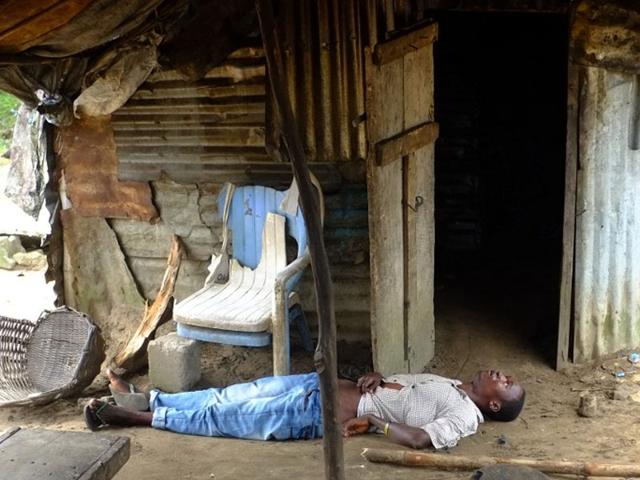Liberia, Banjol: September 4, 2014 A man infected with the Ebola virus lies unconscious in his house on at the small city of Banjol, 30 kilometers of Monrovia. The Ebola virus has killed over 1,500 people in four west African countries since the start of the year, spreading through contact with infected bodily fluids. (AFP/Dominique Faget)