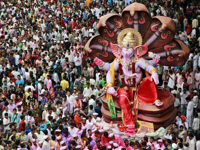 A huge idol of Lord Ganesh is taken in a procession for immersion in the Arabian Sea on the final day of Ganesh Chaturthi in Mumbai on Monday. (AP Photo)