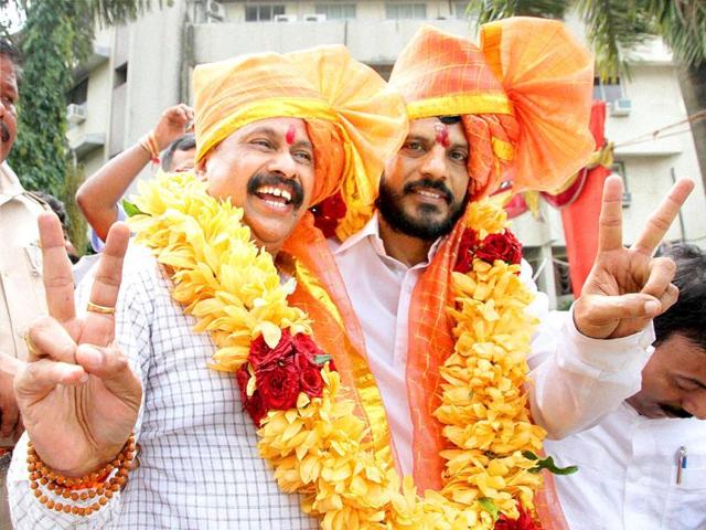 Shivsena corporators Sanjay More and Rajendra Sapte celebrate after winning the posts of mayor and deputy mayor respectively in Thane, Mumbai. (PTI photo)