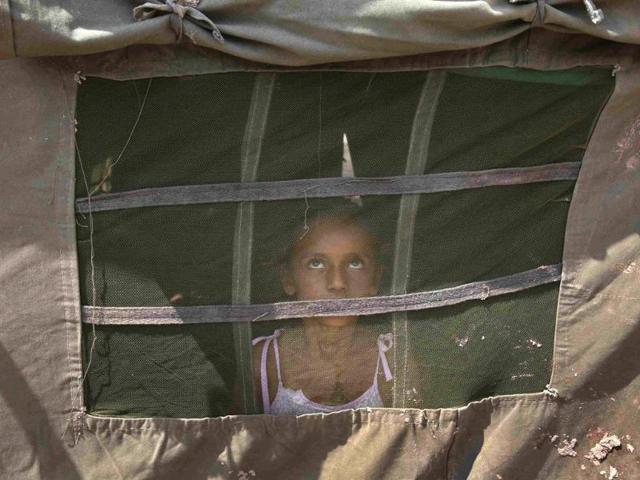 A-girl-from-a-flood-affected-area-watches-a-military-chopper-not-pictured-from-inside-an-Indian-Army-tent-at-a-relief-camp-on-the-outskirts-of-Jammu-Reuters-Photo A-girl-from-a-flood-affected-area-watches-a-military-chopper-not-pictured-from-inside-an-Indian-Army-tent-at-a-relief-camp-on-the-outskirts-of-Jammu-Reuters-Photo