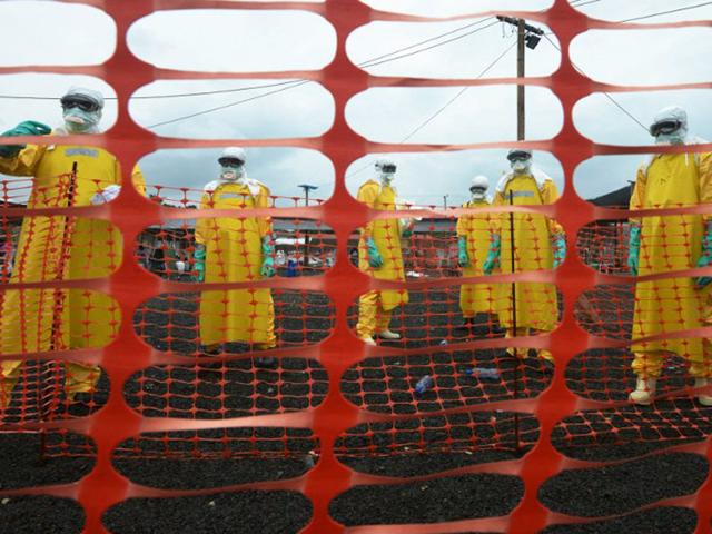Monrovia: September 7, 2014 Workers wearing Personal Protective Equipment (PPE) stand inside the contaminated area at the Elwa hospital run by Medecins Sans Frontieres (Doctors without Borders). (AFP)