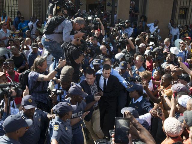 South Africa, Pretoria: September 11, 2014 South African Paralympian athlete Oscar Pistorius (C) leaves the High Court after the verdict hearing of his trial over the killing of his model girlfriend Reeva Steenkamp. Oscar Pistorius was found not guilty of murdering his girlfriend, a shock decision that left the South African celebrity athlete sobbing with emotion in the dock. (AFP)