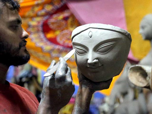 An artist gives gives final touches to an idol of the Goddess Durga ahead of Navratri festival in Mumbai. (PTI photo)