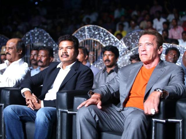 Shankar, flanked by superstars Rajinikanth and Arnold Schwarzenegger watch the audio launch event.