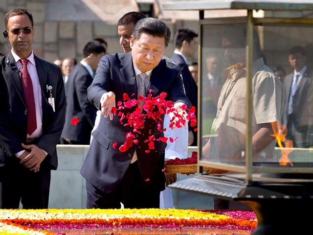 Chinese President Xi Jinping offers a floral tribute at Rajghat, the memorial to Mahatma Gandhi in New Delhi on Thursday. (AP Photo)