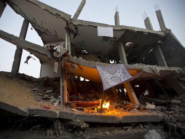 Gaza City: September 24, 2014 A Palestinian boy sits inside the ruins of his family house which was destroyed during the 50 days of conflict between Israel and Hamas, in the Shejaiya neighborhood of Gaza City. (AFP)