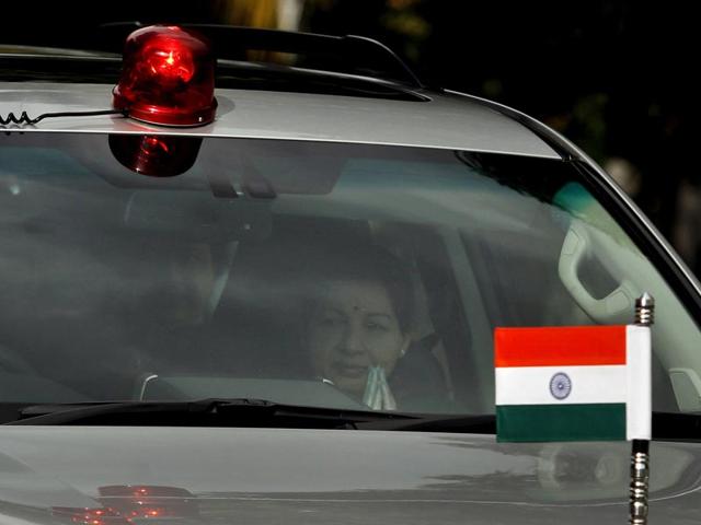 CM Jayalalithaa is seen through the mirror of a car as she comes out of her house in Chennai to appear before a Bangalore court for the verdict. (AP Photo)