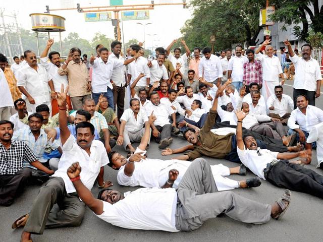 Members of AIADMK holding a protest in Coimbatore over conviction of the party supremo Jayalalithaa by a Bangalore court in a disproportionate assests case. (PTI Photo)