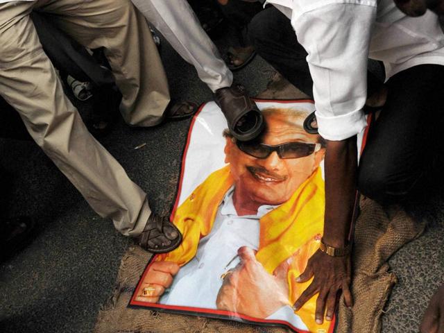Members of AIADMK stomp on a poster of DMK chief K Karunanidhi during a protest following a Bangalore special court pronouncing Tamil Nadu chief minister J Jayalalithaa guilty in a disproportionate assets case, in Coimbatore. (PTI Photo)