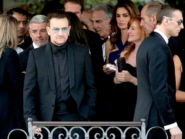 Irish singer Bono, lead vocalist of band U2, arrives to board a taxi boat transporting guests to the venue of a gala dinner ahead of the official wedding ceremony of George Clooney and his fiancee Amal Alamuddin in Venice. (Reuters)