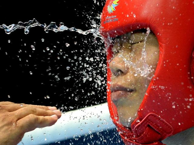 Gold medallist India's Hmangte Chungneijang Mary Kom is splashed with cold water between rounds of the women's flyweight boxing final match against Kazakhstan's Shekerbekova Zhaina during the 2014 Asian Games at the Seonhak Gymnasium in Incheon. (AFP Photo) Gold medallist India's Hmangte Chungneijang Mary Kom is splashed with cold water between rounds of the women's flyweight boxing final match against Kazakhstan's Shekerbekova Zhaina during the 2014 Asian Games at the Seonhak Gymnasium in Incheon. (AFP Photo)