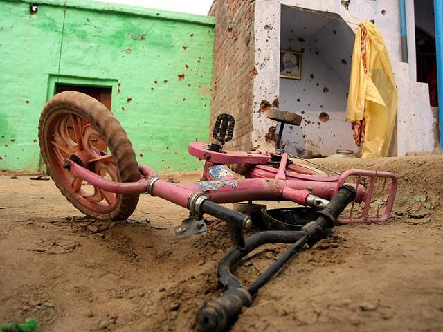 Villagers-show-mortar-shell-marks-on-a-wall-after-indiscriminate-firing-by-Pakistan-Rangers-at-a-residential-area-PTI-Photo Villagers-show-mortar-shell-marks-on-a-wall-after-indiscriminate-firing-by-Pakistan-Rangers-at-a-residential-area-PTI-Photo