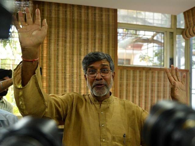 Kailash-Satyarthi-gestures-for-photographers-at-this-home-office-after-the-announcement-of-him-receiving-the-Nobel-Peace-Prize-in-New-Delhi-AFP-Photo Kailash-Satyarthi-gestures-for-photographers-at-this-home-office-after-the-announcement-of-him-receiving-the-Nobel-Peace-Prize-in-New-Delhi-AFP-Photo