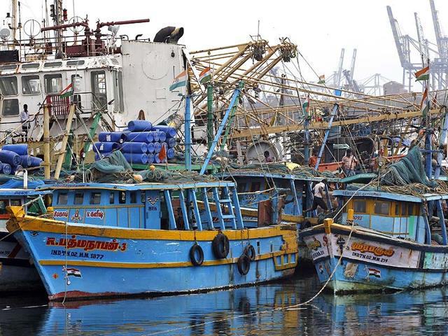 Fisherman dock their fishing boats to a jetty in Chennai. An alert was sounded to the fishermen as cyclone Hudhud is expected to cross the Bay of Bengal coast, according to local reports. (AP Photo)