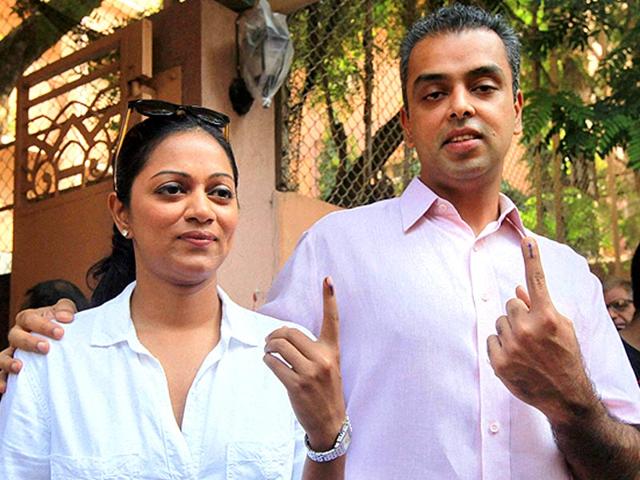 Former MP Milind Deora with his wife, show their inked finger after casting their vote in the assembly elections in Mumbai. (PTI photo)