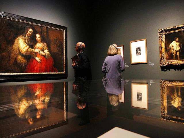 A visitor views a painting (left) entitled Portrait of a couple as Isaac and Rebecca, also known as The Jewish Bride by Dutch artist Rembrandt, during a photocall in the National Gallery in London, on October 14, 2014. The painting is a part of an exhibition entitled Rembrandt: The Late Works, which explores the artist's final years of painting. (AFP) A visitor views a painting (left) entitled Portrait of a couple as Isaac and Rebecca, also known as The Jewish Bride by Dutch artist Rembrandt, during a photocall in the National Gallery in London, on October 14, 2014. The painting is a part of an exhibition entitled Rembrandt: The Late Works, which explores the artist's final years of painting. (AFP)