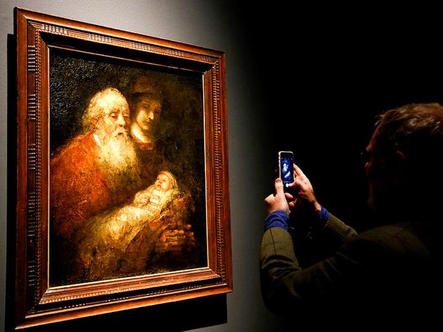 A man photographs Rembrandt's painting Simeon with the Infant Christ in the Temple about 1669, during a media event at The National Gallery in London, Tuesday, October 14, 2014. The National Gallery will be holding an exhibition entitled Rembrant: The Late Works which runs from October 15 until January 18, 2015. (AP) A man photographs Rembrandt's painting Simeon with the Infant Christ in the Temple about 1669, during a media event at The National Gallery in London, Tuesday, October 14, 2014. The National Gallery will be holding an exhibition entitled Rembrant: The Late Works which runs from October 15 until January 18, 2015. (AP)