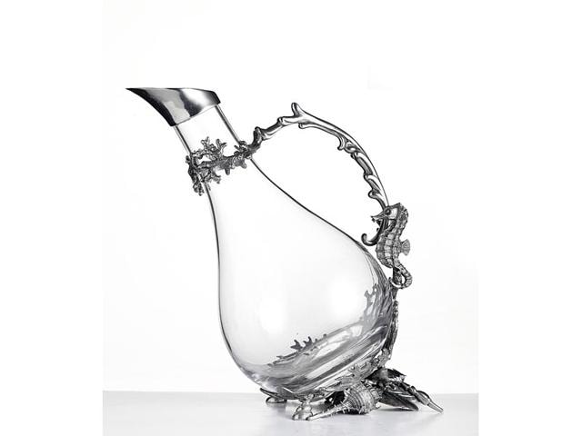 A glass decanter in glass with a silver seahorse handle and silver neck. Available at The Great Eastern Home, Mumbai. Price: Rs 16,088