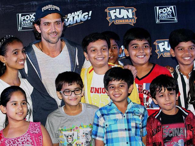 Hrithik Roshan with kids during the special screening of film Bang Bang in Mumbai. (PTI Photo)