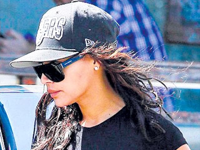 Actor Naya Rivera keeps it simple yet chic in an all-black look of a floaty sundress, sport shoes and baseball cap.