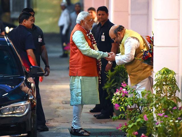Prime Minister Narendra Modi is greeted by BJP President Amit Shah as Modi arrives at the party headquarters to attend the BJP Parliamentary Board meeting in New Delhi. (AFP Photo)