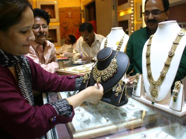 A woman purchases jewellery on the occasion of Dhanteras, in Bhopal on Tuesday. (HT photo)