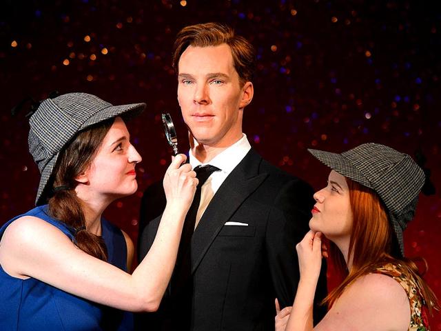 Fans Daisy England (L) and Charlie Mitchell (R) pose with Sherlock Holmes-style deerstalker hats and a magnifying glass around the new wax figure. Dressed in a dark suit the figure of Cumberbatch has been modelled to be premiere ready.(Photo: AFP/ Leon Neal) Fans Daisy England (L) and Charlie Mitchell (R) pose with Sherlock Holmes-style deerstalker hats and a magnifying glass around the new wax figure. Dressed in a dark suit the figure of Cumberbatch has been modelled to be premiere ready.(Photo: AFP/ Leon Neal)
