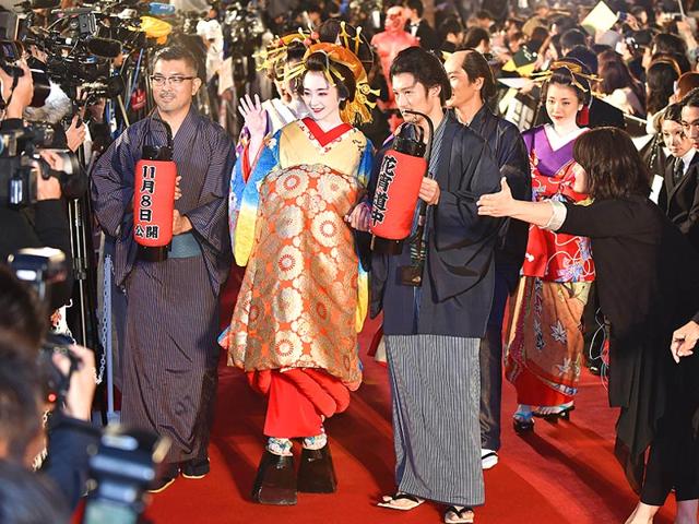 Japanese actor Yumi Adachi (C) clad in traditional kimono costume and actors, who performed in the movie A Courtesan with Flowered Skin, walk on the red carpet for the 27th Tokyo International Film Festival opening ceremony in Tokyo on October 23, 2014. The Tokyo International Film Festival opens on October 23 with its focus heavily on Japanese animated movies and with cult superhero Ultraman set to swoosh down the red carpet with Prime Minister Shinzo Abe. (AFP) 