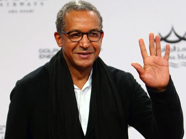 Mauritanian director Abderrahmane Sissako waves as he poses upon his arrival for the opening of 8th edition of the Abu Dhabi Film Festival (ADFF), in Abu Dhabi on October 23, 2014. (AFP)