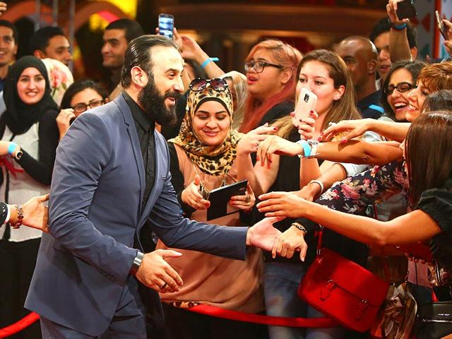 Syrian actor Koussay Khawli is greeted by supporters as he arrives for the opening of 8th edition of the Abu Dhabi Film Festival (ADFF), in Abu Dhabi on October 23, 2014. (AFP)