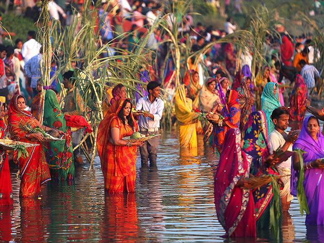 Hindu women perform rituals at sunset to mark Chhath Puja festival in Hyderabad. (AP Photo)