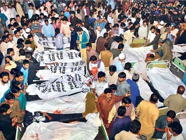 Relatives-gather-beside-the-covered-bodies-of-victims-who-were-killed-in-suicide-bomb-attack-in-Wagah-border-near-Lahore-Reuters-Photo Relatives-gather-beside-the-covered-bodies-of-victims-who-were-killed-in-suicide-bomb-attack-in-Wagah-border-near-Lahore-Reuters-Photo