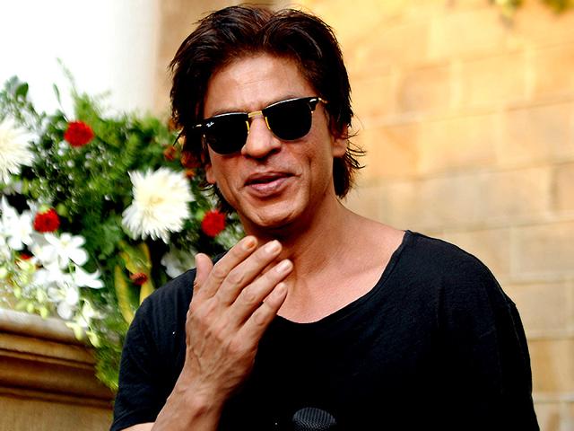Shah Rukh Khan poses for a photograph during a photocall for his 49th birthday celebrations at his home in Mumbai on November 2, 2014. (AFP)