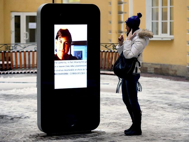 A-woman-stands-next-to-a-screen-showing-a-portrait-of-Steve-Jobs-on-a-memorial-to-late-Apple-Corp-co-founder-in-the-courtyard-of-the-Techno-Park-of-the-St-Petersburg-National-Research-University-of-Information-Technologies-Mechanics-and-Optics-in-St-Petersburg-Russia-AP-Photo A-woman-stands-next-to-a-screen-showing-a-portrait-of-Steve-Jobs-on-a-memorial-to-late-Apple-Corp-co-founder-in-the-courtyard-of-the-Techno-Park-of-the-St-Petersburg-National-Research-University-of-Information-Technologies-Mechanics-and-Optics-in-St-Petersburg-Russia-AP-Photo