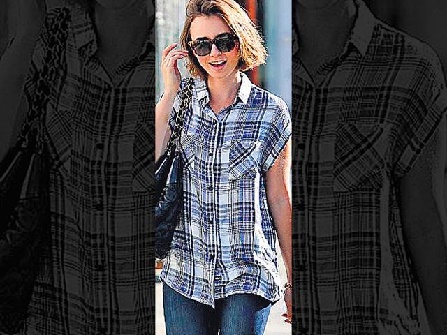 Relaxed chic: Actor Lily Collins wears a short-sleeved plaid shirt over skinny jeans and ankle boots. The lesson to learn is: if your shirt has a loose fit, wear fitted pants to ­balance out the look. A classic black bag and wayfarer completes her look. Relaxed chic: Actor Lily Collins wears a short-sleeved plaid shirt over skinny jeans and ankle boots. The lesson to learn is: if your shirt has a loose fit, wear fitted pants to ­balance out the look. A classic black bag and wayfarer completes her look.