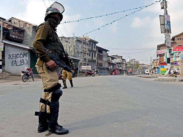 A-security-jawan-stands-guard-during-a-curfew-following-the-killing-of-two-youth-allegedly-in-srmy-firing-in-Srinagar-PTI-Photo A-security-jawan-stands-guard-during-a-curfew-following-the-killing-of-two-youth-allegedly-in-srmy-firing-in-Srinagar-PTI-Photo