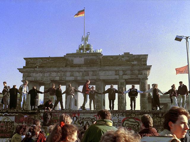In this Nov. 10, 1989 file photo Berliners sing and dance on top of the Berlin Wall to celebrate the opening of East-West German borders. (AP Photo)