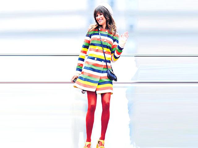 Actor Lea Michele colourblocks her outfit with her vibrant stockings.