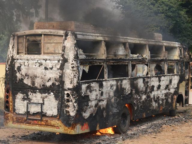 A bus torched by some candidates of Army recruitment test in Gwalior on Wednesday. (HT photo)