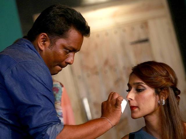 A makeup artist touches up the face of Ileana D'Cruz before a promotional event of Happy Ending in Mumbai. (AP Photo/Rafiq Maqbool)