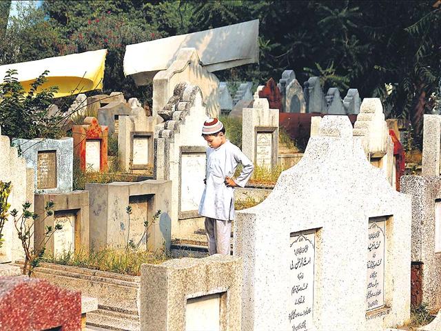 A-young-boy-plays-at-the-Mehndiyan-graveyard-located-behind-the-Lok-Nayak-Jai-Prakash-Hospital-in-New-Delhi-It-is-known-as-the-resting-place-of-of-Muslim-religious-scholars-Photo-Subrata-Biswas-HT