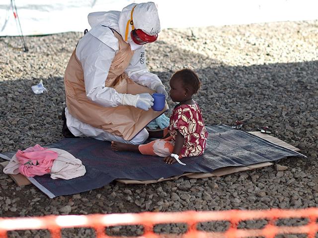 A-health-worker-gives-drink-to-an-Ebola-patient-at-Kenama-treatment-centre--in-Sierra-Leone-The-deadly-virus-has-wreaked-havoc-in-west-Africa-since-an-outbreak-in-March-It-has-already-killed-5-000-people-globally-AFP-Photo A-health-worker-gives-drink-to-an-Ebola-patient-at-Kenama-treatment-centre--in-Sierra-Leone-The-deadly-virus-has-wreaked-havoc-in-west-Africa-since-an-outbreak-in-March-It-has-already-killed-5-000-people-globally-AFP-Photo